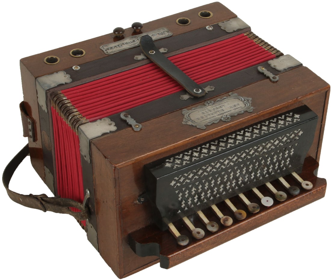 Heligonka, Ceska Rukodilna Harmonik, Ant. Hlavacek v Lounech, Kralovstvi Ceske: 10 treble buttons, 2 bass. Wood finish, silver badge, red bellows, black grille and mother of pearl button heads. Made in Czech Republic. Weight 3.1kg. One mismatched treble button head, marks and wea