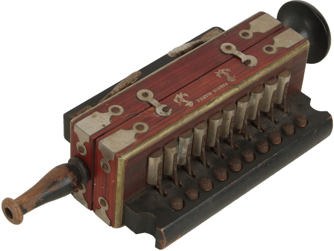 Blow Accordion: 12 buttons, red wood finish, metal corner caps, wood mouthpiece. Unbranded. "Stan C. Moller Walloon Rd. Rosewood" stamped to interior. Weight 0.5kg. Minor rust, dust and marks to finish and mouthpiece