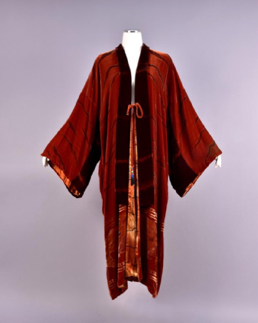 PAINTED VELVET KIMONO, 1920s: Russet silk with brown trim having brown and metallic gold painted tiger stripes, deep hem border of stenciled crouching tigers, printed silk charmeuse lining, single velvet tie with metal and cord ta