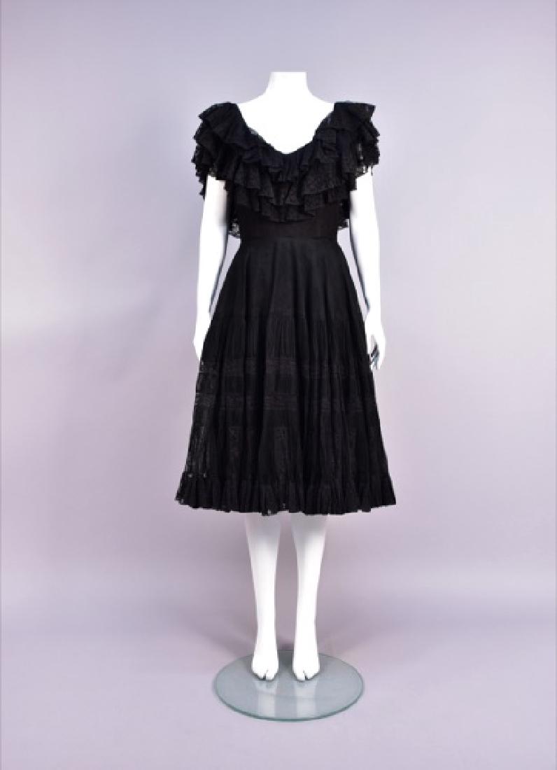 JACQUES FATH FLAMENCO-INSPIRED DRESS, 1950s: Black tulle over taffeta having boned sleeveless bodice with a triple ruffle of pleated tulle with lace borders, set-in waist, full skirt having pleated tiers with lace bands and hem ruffle over layer