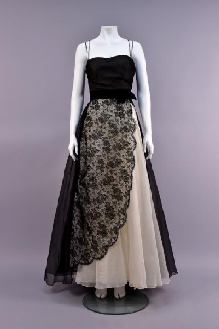 HELENA BARBIERI EVENING DRESS, 1950s: Semi-boned bodice with double spaghetti strap in black organza over white, black velvet waistband with bow, full layered skirt with white center panel having black lace overlay, scalloped in a curve t