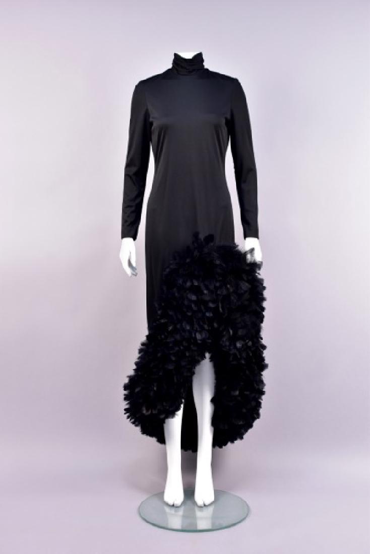 LILLI DIAMOND FEATHER-TRIMMED EVENING DRESS, 1970s: Long sleeve black jersey knit column with ruched turtleneck and angled hem decorated with a wide band of rooster feathers. Labeled. B-34, W-30, H-36, L 35-56. Excellent.