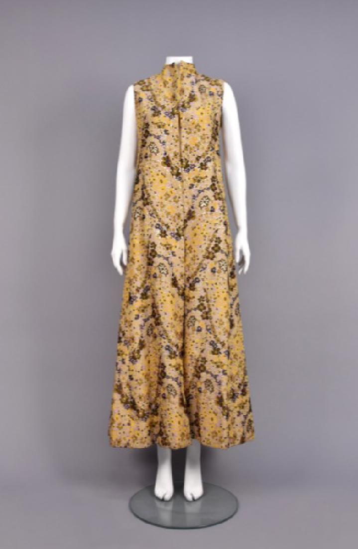 GUY LAROCHE METALLIC BROCADE LONG VEST: Polychrome floral on metallic gold ground, collarless wide A-line, lined in goldenrod silk satin, no closures. Labeled. B-36, L-56. Excellent.