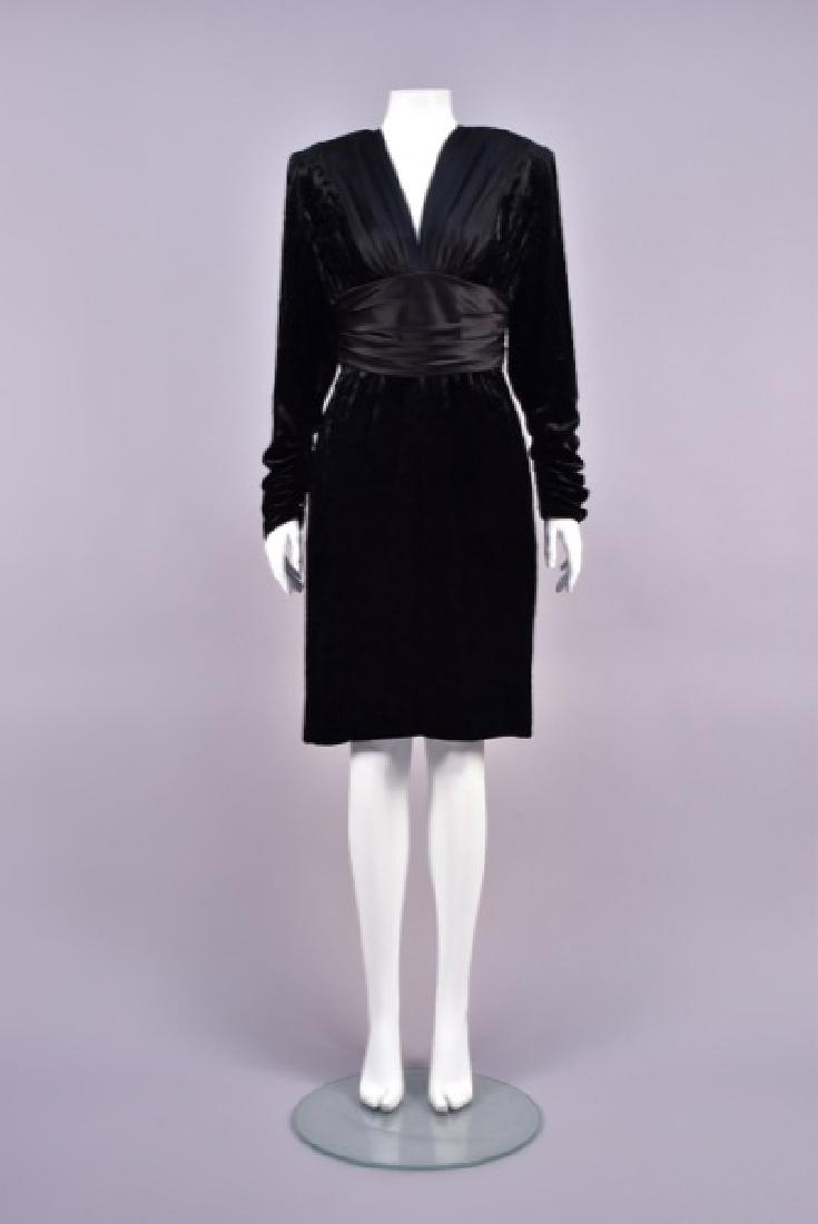 GALANOS CRUSHED VELVET COCKTAIL DRESS, 1986.: Black silk with long sleeve gathered into a wrist zipper, the bodice having wide charmeuse bands flanking a V-neck and gathered into a cummerbund ruched at the side seams and back zipper, gathered ski