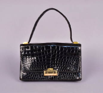 HERMES ALLIGATOR BAG, MID 20th C.: Envelope style with top handle, brass hardware, divided leather interior with three open and one snap pocket. Labeled, clasp marked HermÃ©s. 10 x 6 1/2 x 2 with 6-inch handle. (Slight wear to corner