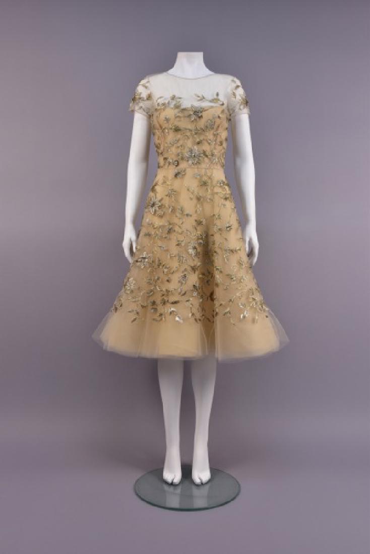 OSCAR de la RENTA METALLIC EMBROIDERED COCKTAIL DRESS: Cream silk with layers of chiffon and tulle having short sleeve bodice with sheer top, decorated in silver and gold metallic satin stitch floral with silver beads and gold sequins, full skirt. Labeled