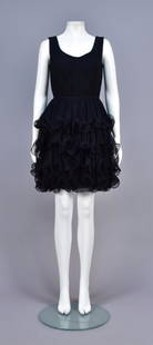 TRAVILLA PLEATED CHIFFON COCKTAIL DRESS, 1960s: Sleeveless black silk having scoop neck bodice with chiffon pleats set in waist, slight A-line skirt having five tiers of concertina pleats with corded serpentine hems, silk underskirt. Travilla and L