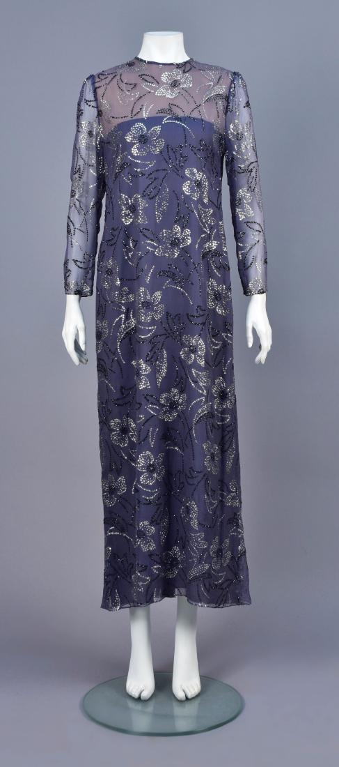 RICHILENE GLITTER FLORAL CHIFFON GOWN, 1970s: Grey silk with sheer long sleeve and bodice top, having a whimsical floral in grey and silver glitter, back hem slit, grey under-dress. Labeled. B-38, W-34, H-40, L-54. Excellent.
