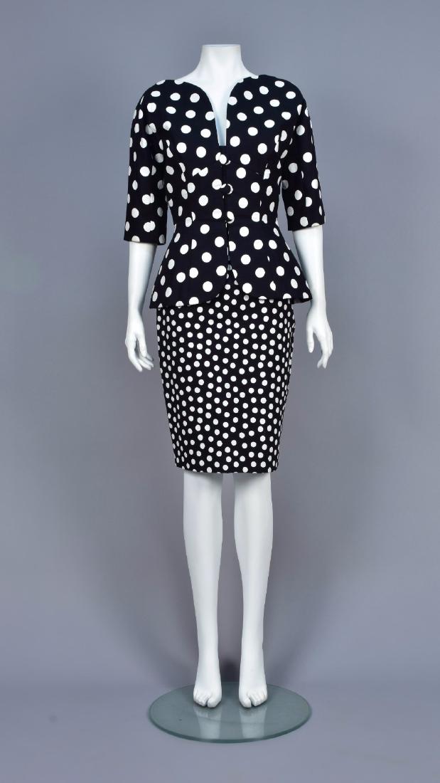 VICKI TIEL DOTTED COTTON SKIRT SUIT, 1980s: Black piquÃ© with white dots, peplum jacket having short sleeve, curved V-neck, button & loop closures, pencil skirt with smaller dots and back slit. Labeled. B-34, jacket L-23, W-26, H-34, skirt L-