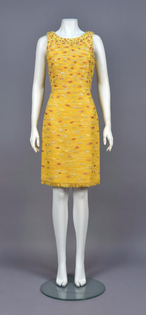 OSCAR de la RENTA COTTON and SILK DAY DRESS: Sleeveless ribbed weave in white, copper and yellow on gold ground with looped decoration around neckline and armhole, fringed at the hem. Labeled. B-36, W-30, H-38, L-39. Excellent.