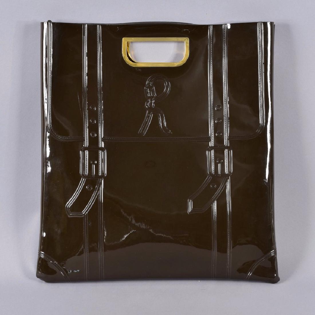 ROBERTA de CAMARINO EMBOSSED VINYL TOTE BAG: High gloss brown embossed with luggage straps and signature "R" on both sides, gold tone D-shaped handles. 16 x 17 x 1. (Two slight narrow scuffs) excellent.
