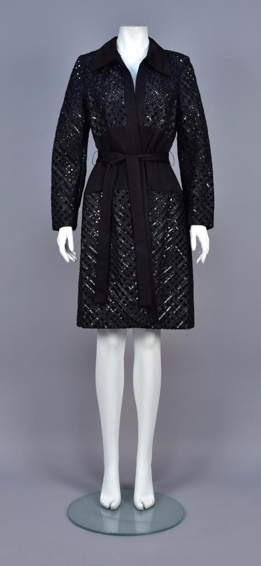 DOUGLAS HANNANT OPENWORK BEADED COAT: Black silk in a diamond lattice decorated with black sequins and tiny beads having a linen-look collar, midriff band, front edge and belt. B-38, Sh-15, Slv-23, L-41. Excellent.