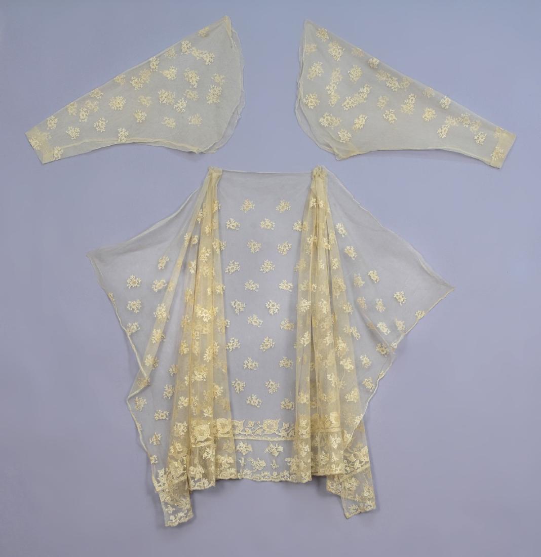 NEEDLERUN LACE OVERSKIRT and MATCHING SLEEVES, 1820s: Cream net with clusters of flowers, skirt having floral border and hem ruffle, matching gigot sleeves. Skirt 34 x 79, (seamed, spots, small holes and mends) good, sleeves L-26, (few spots) very good.