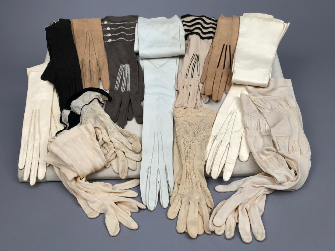 TWELVE PAIR LADIES' GLOVES, 19th - early 20th C: Six pair leather including one pair shoulder-length, six pair silk including three with stripes and one pair knit with lace. Good-excellent.