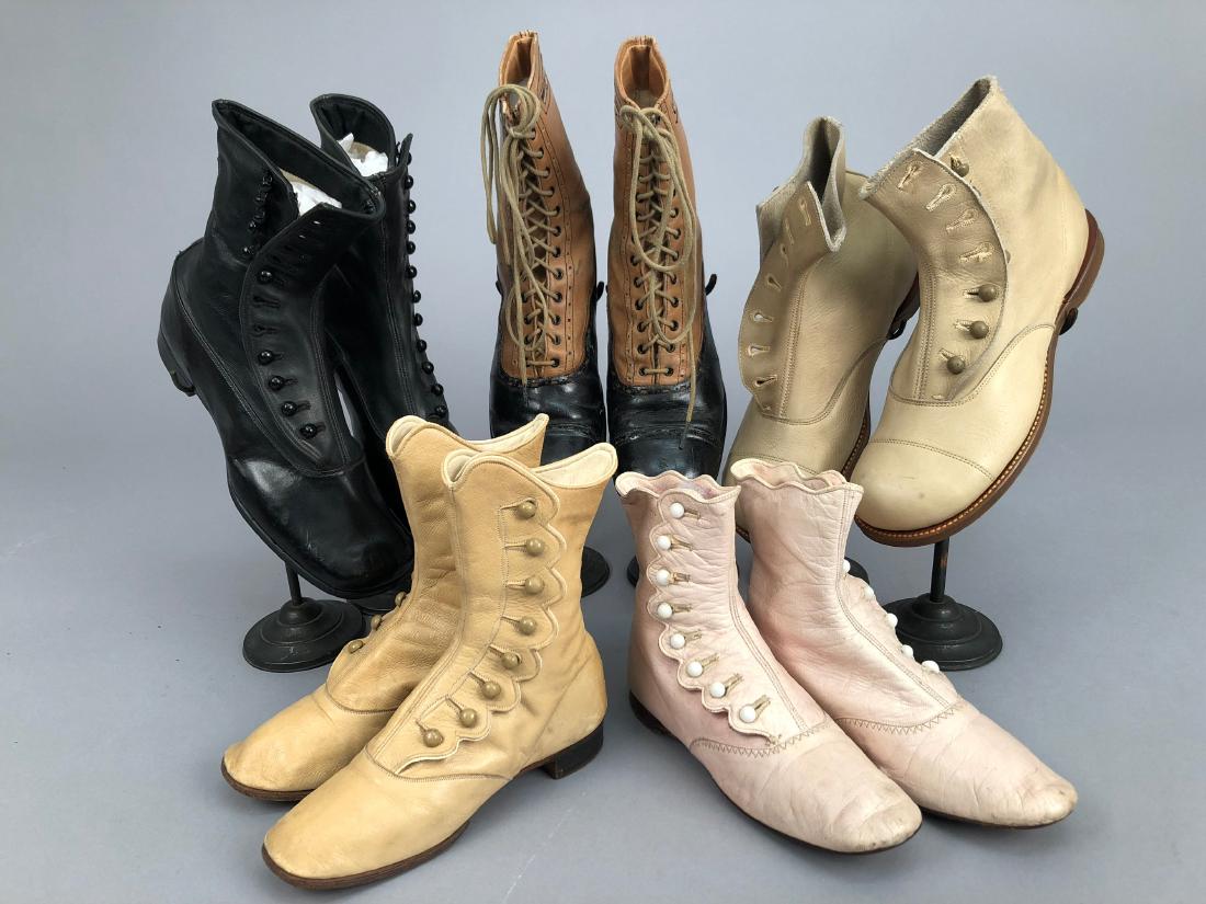 FIVE PAIR CHILDRENS BOOTS, 1900 - 1910: One pair tan and black leather spectator-style lace-ups, label "Walton Waterproof"; four pair side-buttoning: one pair bone "Little Chums", one pair unworn black "DeBartolo Los Angles", one pair pink