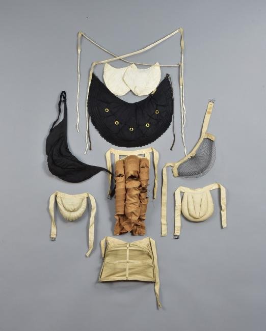 LOT of SEVEN BUSTLES, 1870s - 1890s: Three coiled metal: One double-coil with white cotton cover, 6 x 6; one double-coil with horsehair pads and black cotton cover, 13 x 6, (slightly crushed); one having five coils and brown cotton cover