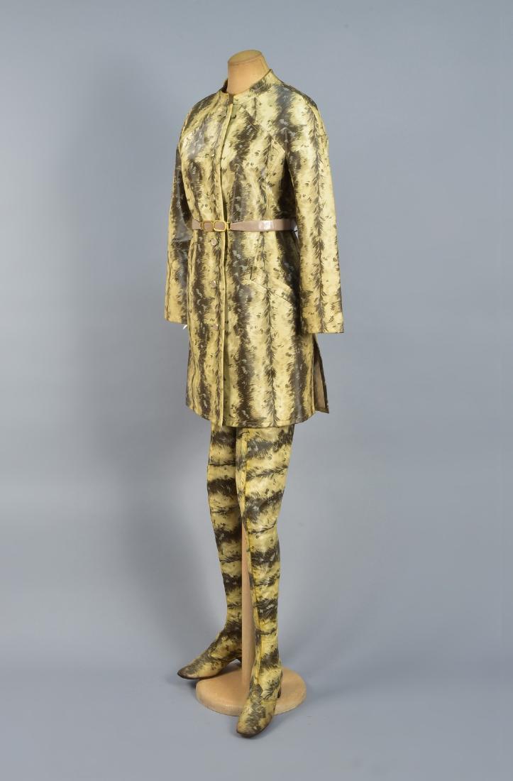de BARENTZEN RAINCOAT and THIGH-HIGH BOOTS, 1967: Vinyl with a stylized fur print in pale yellow, grey and brown, having band collar, raglan sleeve, angled seam details and pockets, taupe leather belt having gilt buckle, gilt buttons with leather ins