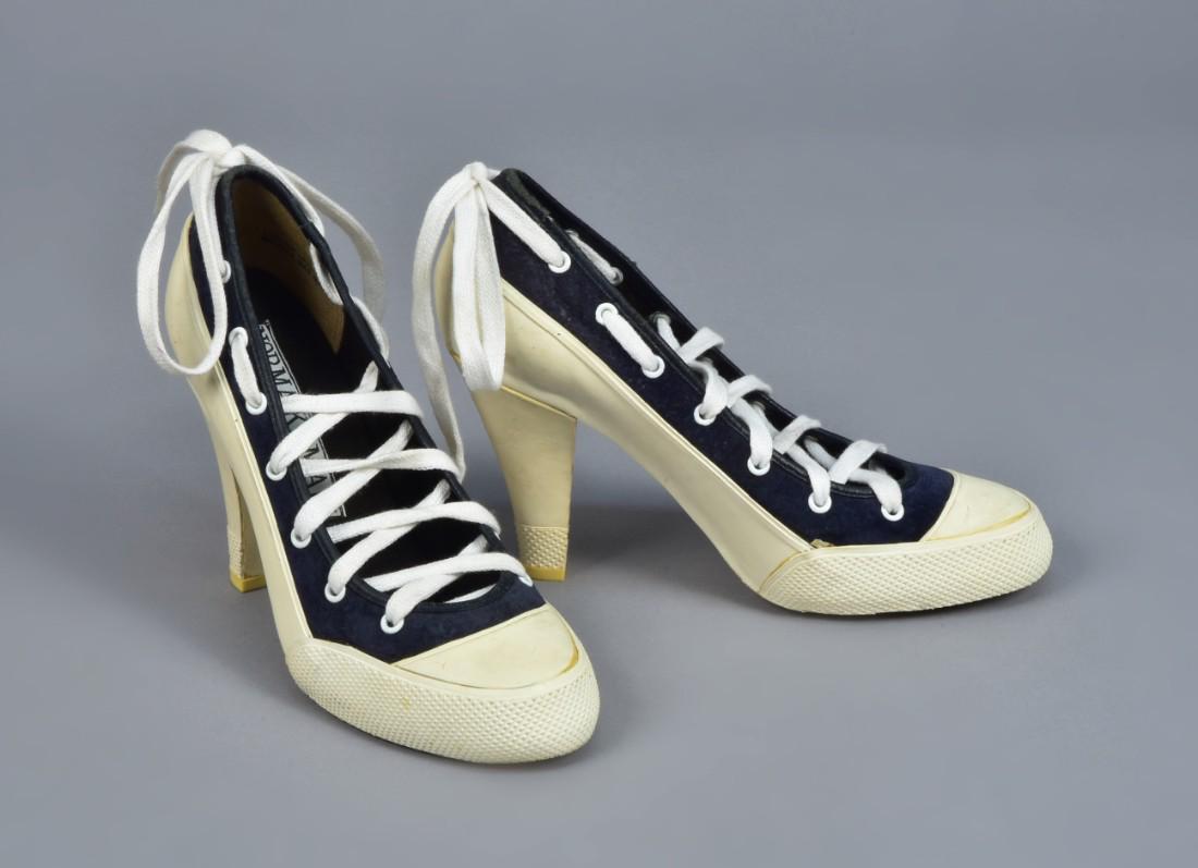 NORMA KAMALI HIGH-HEEL SNEAKERS, 1980s: Black suede and white rubber, having white grommets and ankle laces. Labeled. Size 7B. (Very minor wear, laces replaced) excellent.