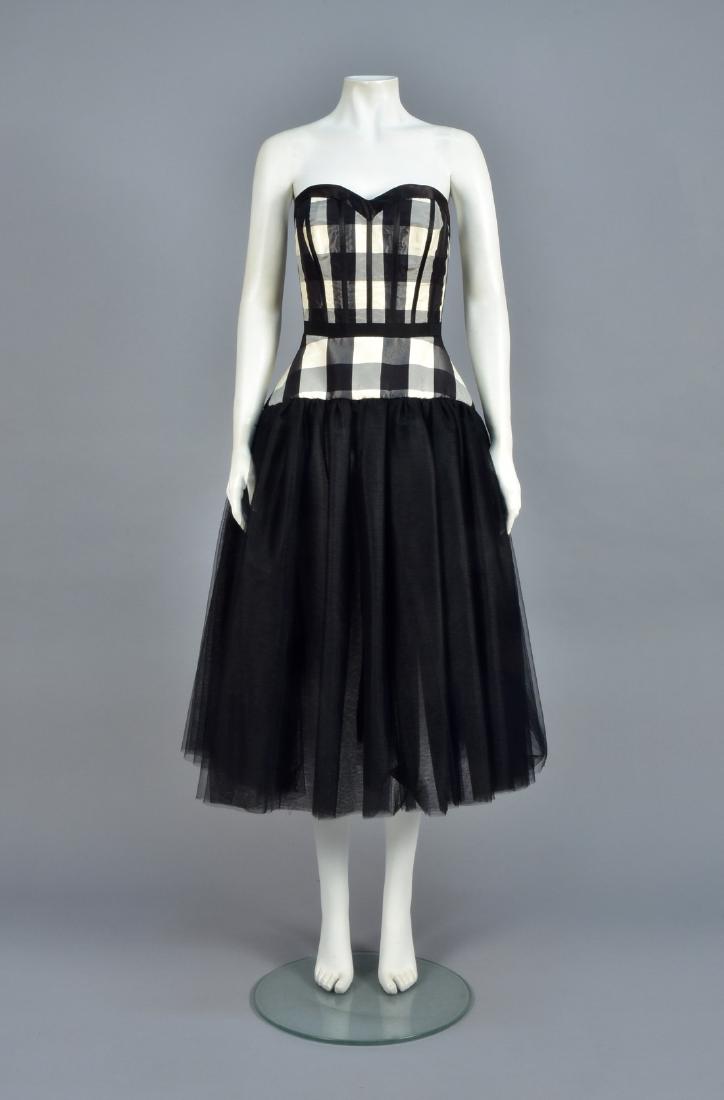 GALLIANO STRAPLESS PLAID DRESS with NET POUF, 2000: Black-and-white plaid silk having back-lacing sweetheart bodice with satin binding and ribbon bands to accent the boning, grosgrain ribbon waistband, full skirt of three layers of black tulle gathered