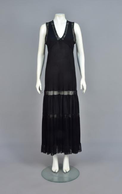 GAULTIER SOLEIL RESORT MAXI DRESS: Black synthetic knit, sleeveless high-waist bodice with perforated weave, the V-neck and armhole edged in yarn net, tiered skirt with perforated and net bands, ruffled hem, labeled. B-34, L-56. (Tiny 