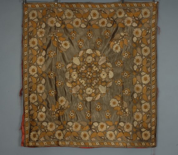 EASTERN SILK EMBROIDERED TABLE COVER, 19th C Grey : EASTERN SILK EMBROIDERED TABLE COVER, 19th C Grey satin with allover couched floral embroidery in white, mushroom and fawn, backed in red silk. 52 x 48 1/2. Lining poor, few small holes to silk ground