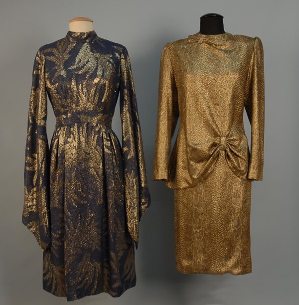 TRIGERE DRESS WITH EXAGGERATED BELL SLEEVES, 1960s: TRIGERE DRESS WITH EXAGGERATED BELL SLEEVES, 1960s-1970s Gold on navy brocade with long and wide bell sleeve, chiffon skirt lining, back zipper. Pauline Trigere label. Bust 36, waist 28, length 46. Fe