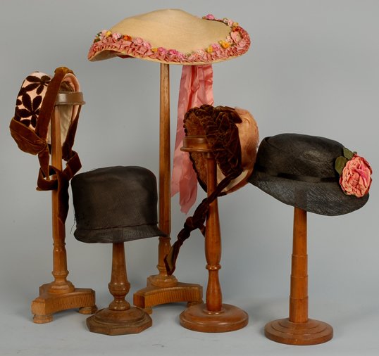 FIVE LADIES' HATS, LATE 19th- EARLY 20th C Paris n: FIVE LADIES' HATS, LATE 19th- EARLY 20th C Paris natural straw trimmed with ring of cloth flowers and ruched pink satin ribbon, ribbon bow beneath brim. Two pink silk and brown velvet bonnets. Black s