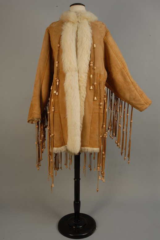 DORIS DUKE'S BEADED and FRINGED SHEARLING COAT, 19: DORIS DUKE'S BEADED and FRINGED SHEARLING COAT, 1960s Tan coat with long wood beaded fringe to sleeves and back waistband, extending below hem. Lush cream fur lining and trim, side seam pockets, two h