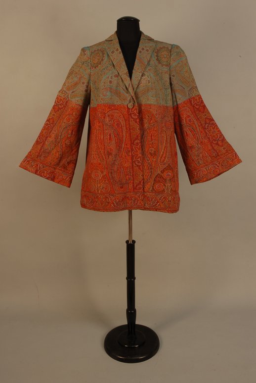 LADY'S KASHMIRI PAISLEY JACKET, 20th C Long jacket: LADY'S KASHMIRI PAISLEY JACKET, 20th C Long jacket with bell sleeve, styled from a 19th C paisley shawl, the top section on an aqua ground, the bottom in a palette of reds, lined in silk. Bust 44, sho