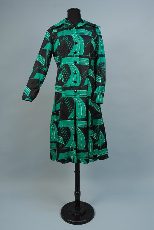 PAULINE TRIGERE PRINTED SILK DAY DRESS, 1970s Gree: PAULINE TRIGERE PRINTED SILK DAY DRESS, 1970s Green, white and black abstract print with spread collar, front has six black plastic buttons, long sleeves with zippers at wrist, label "Pauline Trigere"