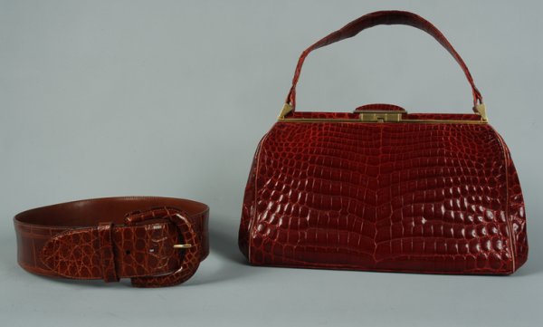ALLIGATOR HANDBAG and WIDE BELT, 20th C DDCF. Red : ALLIGATOR HANDBAG and WIDE BELT, 20th C Estate of Doris Duke to benefit DDCF. Red bag, brass hardware with slide clasp, red leather interior with four open and one zippered pocket, stamped in gold "Ma