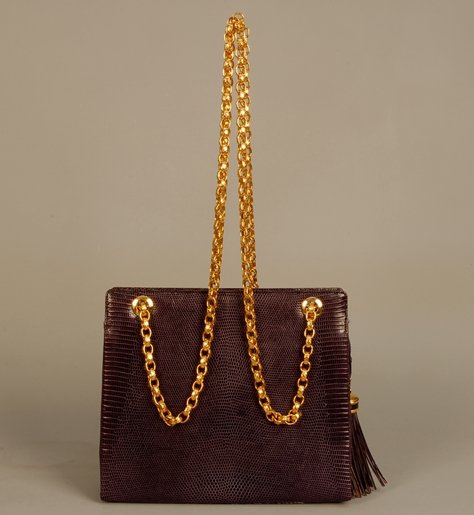 LUC BENOIT PURPLE LIZARD HANDBAG, LATE 20th C Squa: LUC BENOIT PURPLE LIZARD HANDBAG, LATE 20th C Square bag with embossed brass link double chain strap, zip closure with lizard and brass tassel, three interior pockets. 8 x 9 1/2 with 18 1/2 inch strap