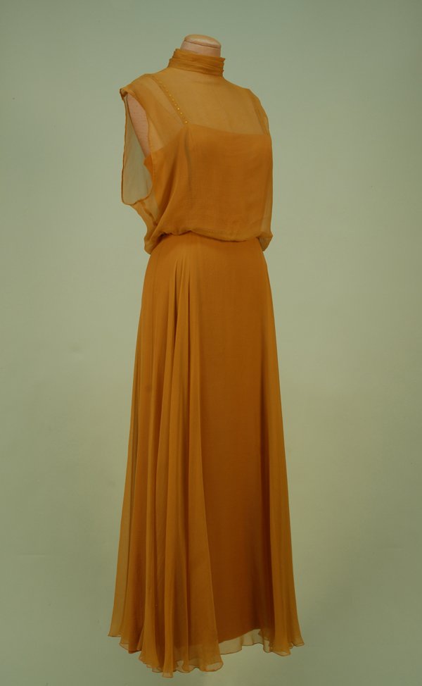 LATIMER FOR IRENE LAYERED CHIFFON EVENING GOWN, 19: LATIMER FOR IRENE LAYERED CHIFFON EVENING GOWN, 1960's. Gold silk crepe under chiffon with spaghetti straps studded with gold "jewels", full skirt all beneath chiffon layer with high neck blouson slee