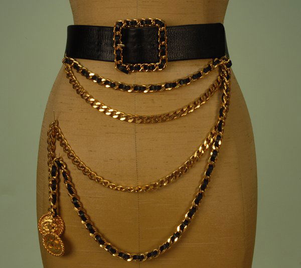 CHANEL LEATHER and BRASS CHAIN LINK BELT, LATE 20t: CHANEL LEATHER and BRASS CHAIN LINK BELT, LATE 20th C. Wide black leather having square brass link buckle laced with leather, double chain swag attaches to hook across front, one chain laced with leat
