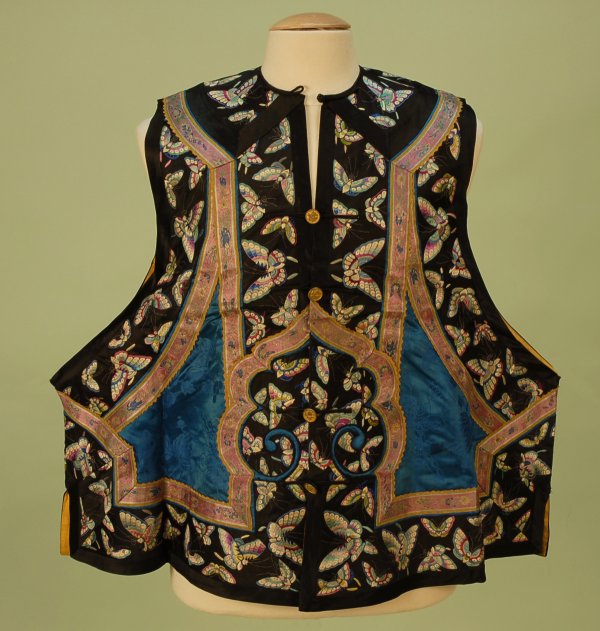 MAN'S CHINESE EMBROIDERED SILK SLEEVELESS JACKET, 1: MAN'S CHINESE EMBROIDERED SILK SLEEVELESS JACKET, 1920's. Blue damask having wide black satin border decorated with colorful butterflies, front and back cartouche, silk loop and brass button closures,