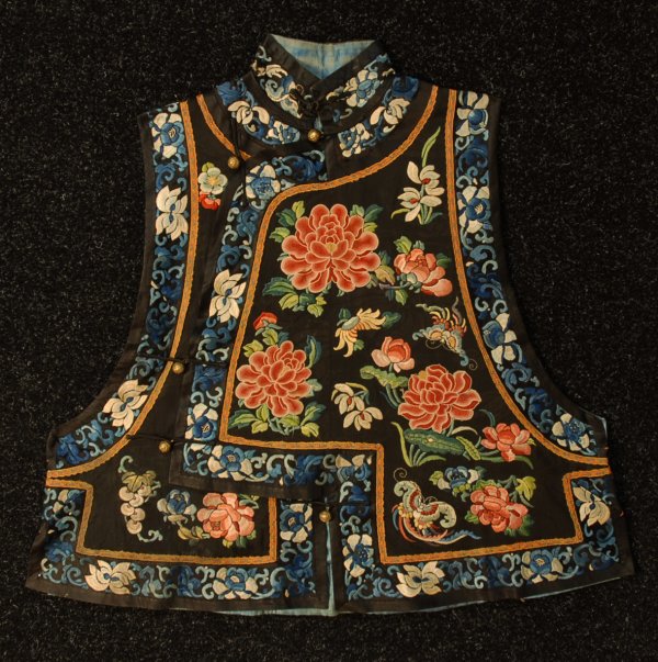 CHINESE EMBROIDERED SILK VEST, c. 1900. High Manda: CHINESE EMBROIDERED SILK VEST, c. 1900. High Mandarin collar with five brass frogs and one knotted fabric frog closure, decorated with embroidered peonies and butterflies, bordered in blue and white f