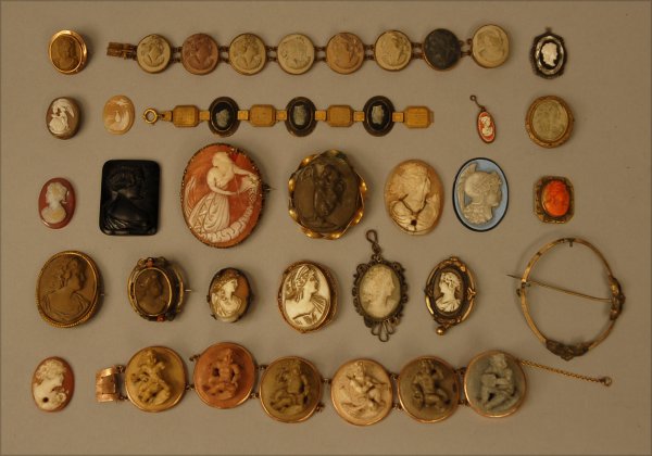 LOT of VICTORIAN CAMEO JEWELRY. Consisting of pins: LOT of VICTORIAN CAMEO JEWELRY. Consisting of pins, lockets, bracelets and loose cameos carved from various materials including shell, basalt, coral, and glass. Poor-excellent.