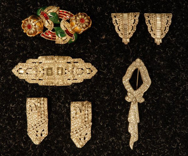LOT of PASTE JEWELRY, 1920's. Bow pin, 4 inches. P: LOT of PASTE JEWELRY, 1920's. Bow pin, 4 inches. Pair of Deco clips joined as a brooch, 3 1/2 x 1 1/4. Two pair dress/ shoe clips, 2 x 7/8 and 1 1/4 x 1 3/16, one stone missing. Together with a Coro "