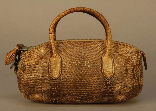HERMES LIZARD PURSE, 1927. Small twin handled duff: HERMES LIZARD PURSE, 1927. Small twin handled duffle with zipper, padlock and two keys in brown lizard with tan leather lining. Unlabeled but zipper tab marked "Hermes". 5 x 7 1/2 with 3 inch handle.