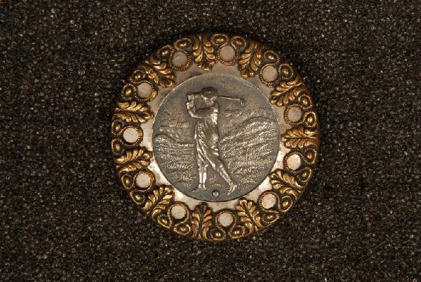 RARE and UNUSUAL STAMPED METAL GOLFER BUTTON. Large siz: RARE and UNUSUAL STAMPED METAL GOLFER BUTTON. Large size having white metal swinging golfer in landscape center medallion, surrounded by a flat ring of steel or tin with rolled reticulated circle and 