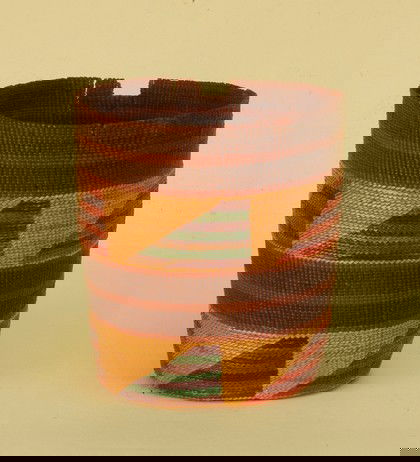 NATIVE AMERICAN HAIDA BASKET, 1900-1930. Fine example w: NATIVE AMERICAN HAIDA BASKET, 1900-1930. Fine example with strong colors, two horizontal bands of brown with red stripe over natural band decorated with "sail" designs in red, green, blue and purple.