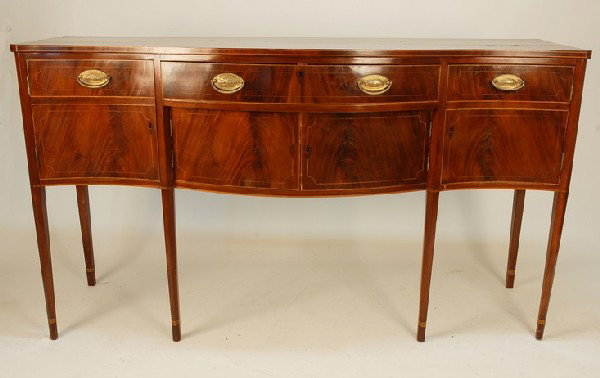 HEPPLEWHITE INLAID SIDEBOARD, c. 1800. Serpentine top o: HEPPLEWHITE INLAID SIDEBOARD, c. 1800. Serpentine top over inlaid central drawer, flanked by two cupboard doors with faux drawer on tapering banded legs. 71 x 23 x 40 1/2. Excellent.