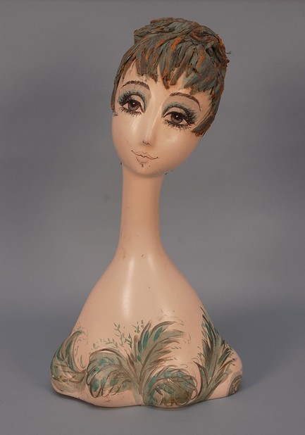 HAND PAINTED COMPOSITION DISPLAY HEAD, 1960's. Yo: HAND PAINTED COMPOSITION DISPLAY HEAD, 1960's. Young woman with elongated neck whimsically painted in aqua and grey on cream and having papier mache hair. Minor cracks at base, some paint loss to hair