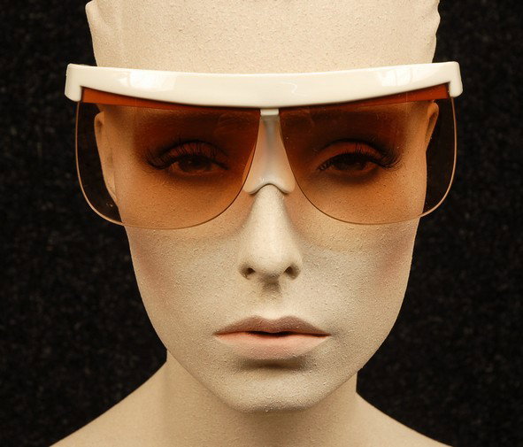 COURREGES SUNGLASSES, 1960's. White plastic frame: COURREGES SUNGLASSES, 1960's. White plastic frame with molded nosepiece, marked "Courreges Paris" and "France 7853 04", with original white vinyl drawstring pouch. Minor nicks to lenses, glasses very 