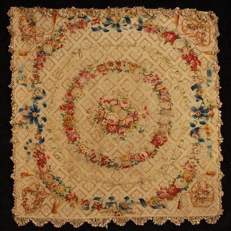 FRINGED AUBUSSON TAPESTRY TABLE COVER, 19th C. Cen: FRINGED AUBUSSON TAPESTRY TABLE COVER, 19th C. Central floral medallion in red, ivory and green within a double ring of flowers, the outer having a twisted blue ribbon, corners having a knotted rope d