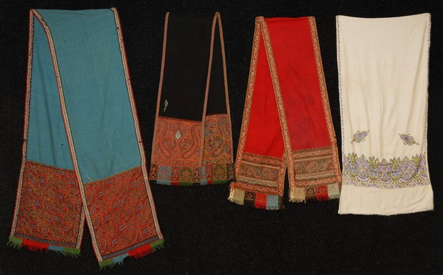 THREE WOOL PAISLEY STOLES, 19th C. One turquoise f: THREE WOOL PAISLEY STOLES, 19th C. One turquoise field, one red, one black. Each approximately 14 x 40. Good. Together with a white silk stole embroidered in plum and green, excellent.