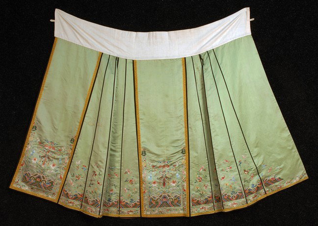 CHINESE SILK EMBROIDERED SKIRT, 19th C. Pale celad: CHINESE SILK EMBROIDERED SKIRT, 19th C. Pale celadon satin embroidered in satin and forbidden stitches, center panel having bats, symbols and rainbow ocean waves in multicolor silk and couched metalli