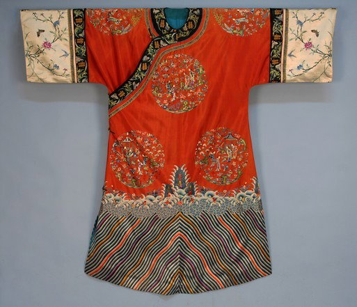 CHINESE SILK ROBE, 19th C. Orange satin with short: CHINESE SILK ROBE, 19th C. Orange satin with short wide sleeve having white sleeve band, the robe decorated with embroidered roundels with figures in landscapes, bottom multicolored wave border, excel