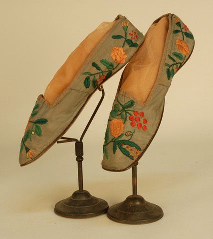 LADY'S FLORAL EMBROIDERED SILK SHOES, LATE 18th C.: LADY'S FLORAL EMBROIDERED SILK SHOES, LATE 18th C. Grey faille flat straights having square toe, the vamp and quarter decorated with red, apricot and green silk satin stitch flowers, silk bengaline bi