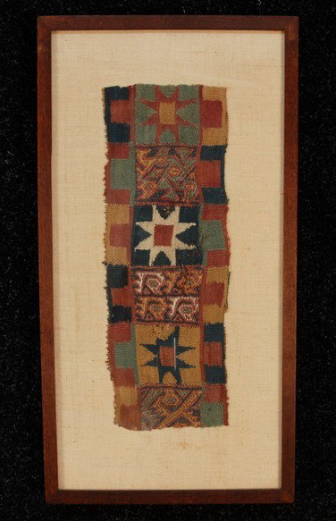 FRAMED PERUVIAN TEXTILE FRAGMENT, 1100-1400 A.D. C: FRAMED PERUVIAN TEXTILE FRAGMENT, 1100-1400 A.D. Colorful wool tapestry weave with eight pointed stars and geometric elements. 5 x 12 1/2.